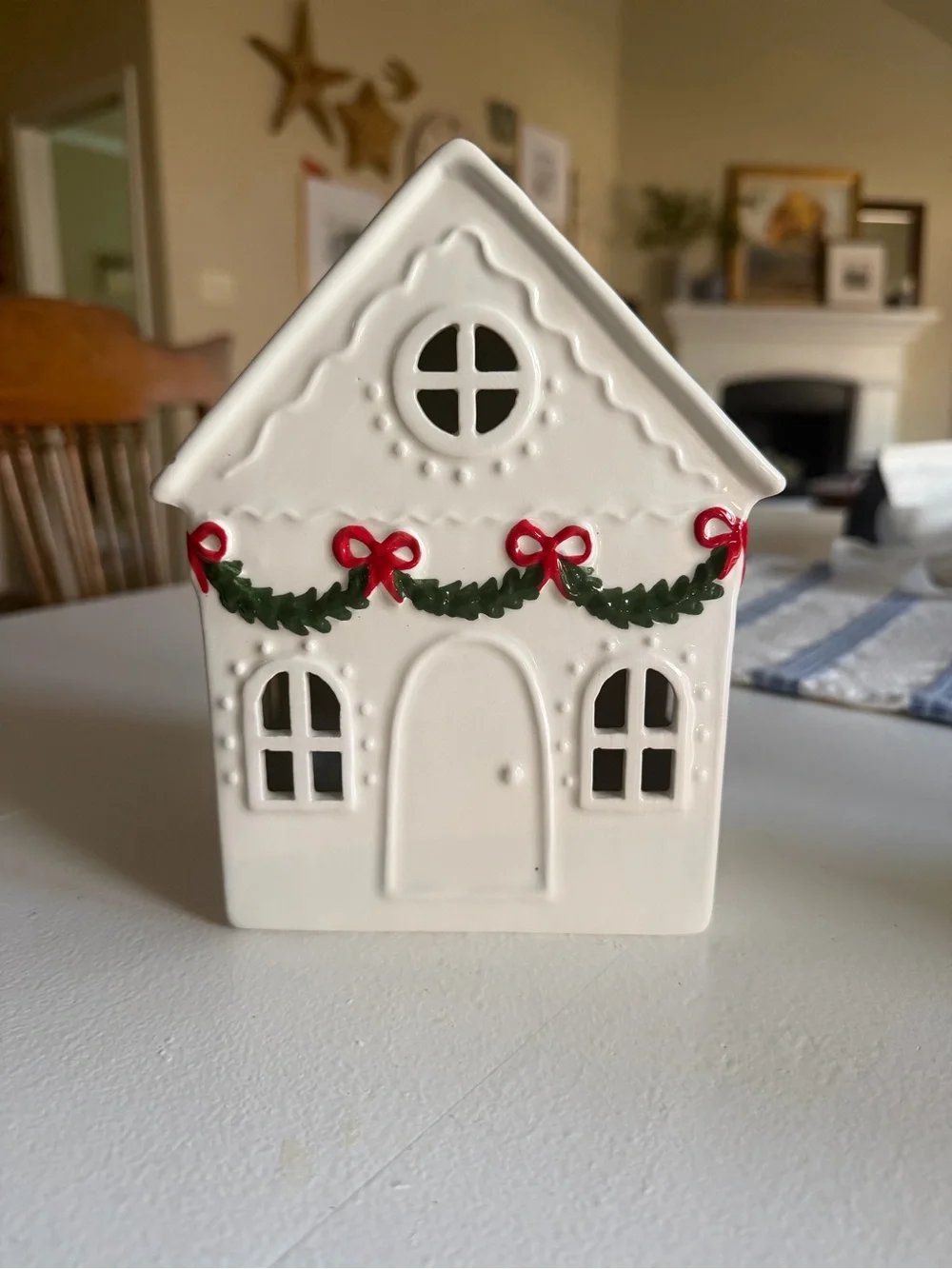 White Ceramic Holiday House with Green Garland and Red Bows